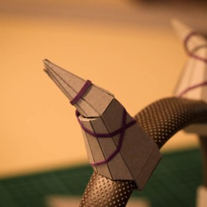 Use an elastic band to hold the horns in place