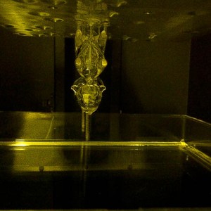 The print is held to the build platform with support structures that look very alien